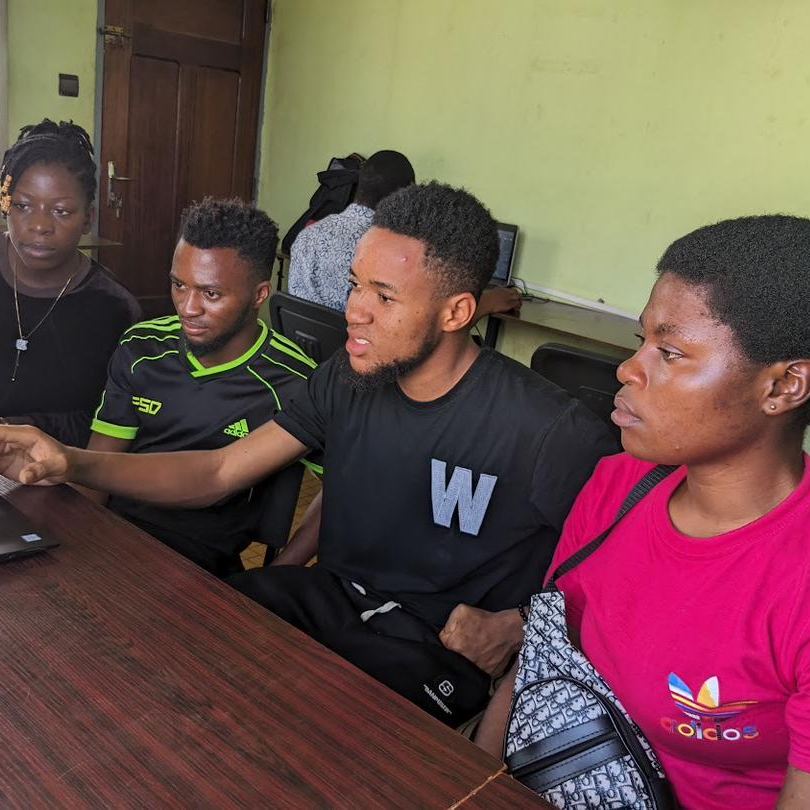 Students learning computer skills with a supervisor at our tech partner Skye8