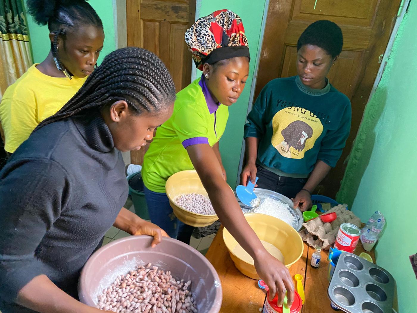 Trainees mixing ingredients in large bowls