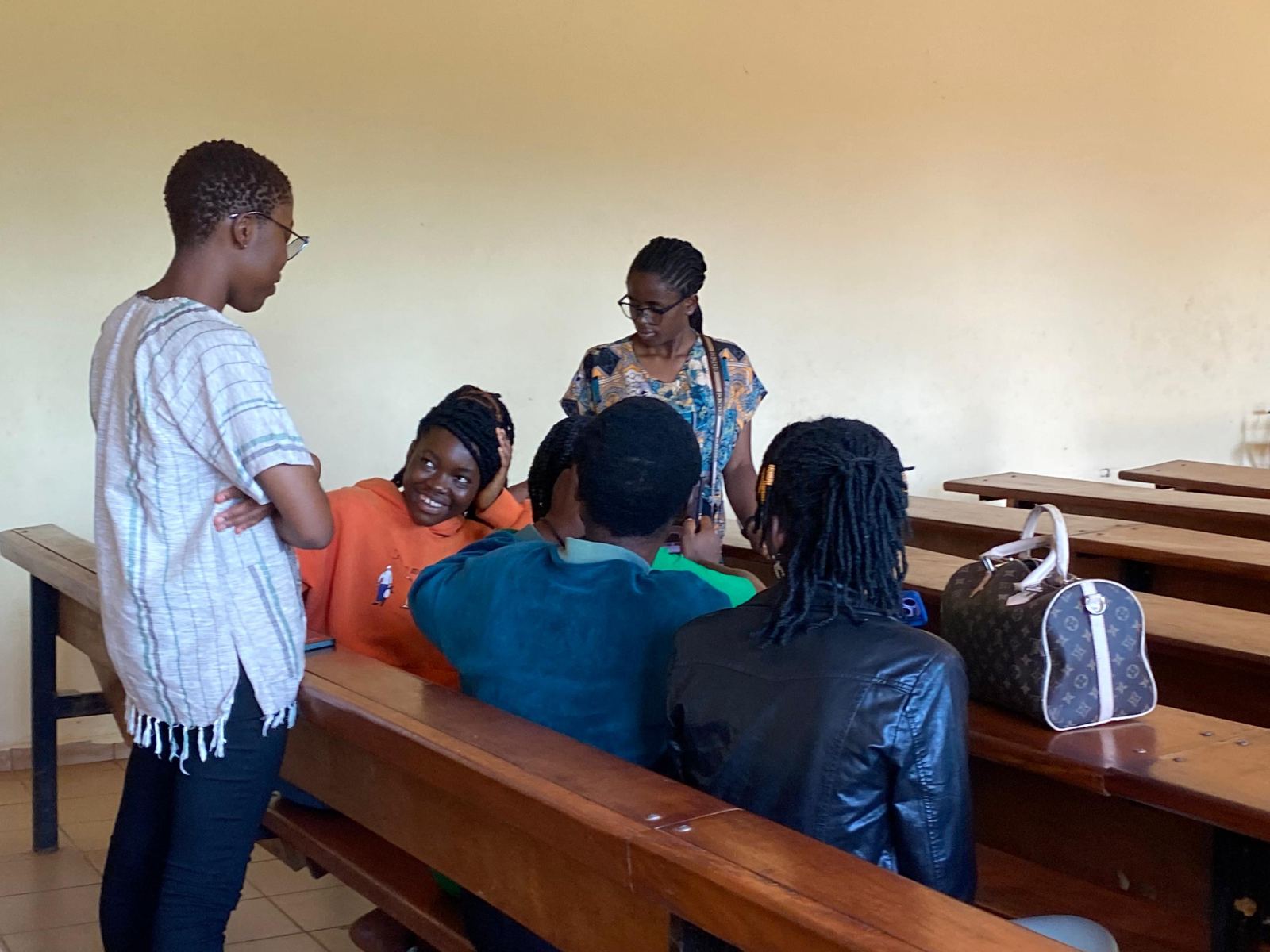 Trainers talking with students in a classroom
